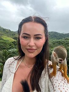 A photograph of Xeorelle with a monkey on her shoulder